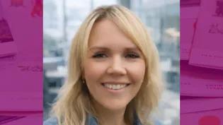 Colour head and shoulders photo of Amy Wilson smiling at the camera