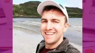 Colour head and shoulders photo of Euan Meston smiling at the camera