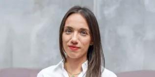 Colour head and shoulders photo of Sophie Bayer-Blears smiling at the camera