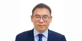 Colour head and shoulders photo of Ximian Xu smiling at the camera