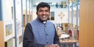 Colour head and shoulders photo of Canon Anderson Jeremiah smiling at the camera