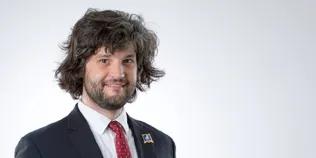 Colour head and shoulders photo of Austin Freeman smiling at the camera