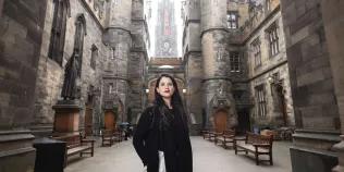 Colour head and shoulders photo of a student stood in the New College Quad