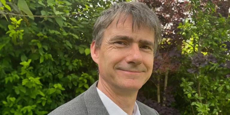 Colour head and shoulders photo of Professor Gordon Lynch smiling at the camera