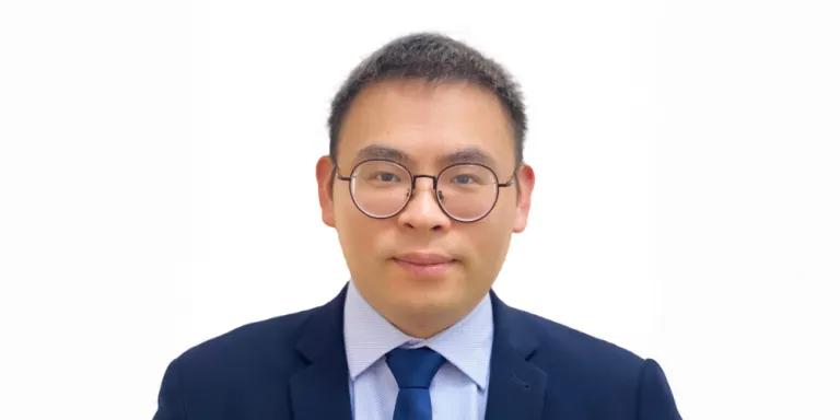 Colour head and shoulders photo of Ximian Xu smiling at the camera