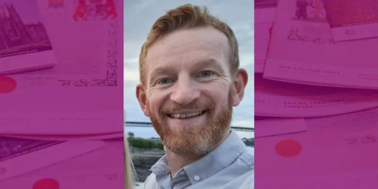 Colour head and shoulders photo of Angus Moyes smiling at the camera
