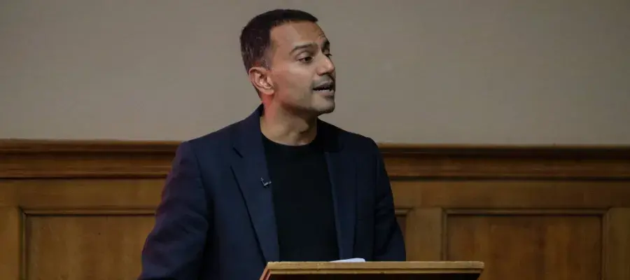 Colour head and shoulders photo of Dr Shadaab Rahemtulla speaking at the lectern in the Martin Hall