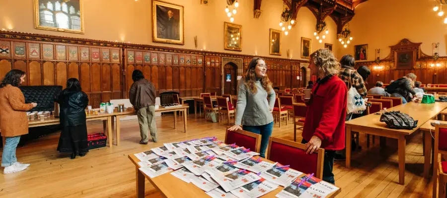 Colour photo of guests and students stood in Rainy Hall talking to one another as part of the School of Divinity's Open Day