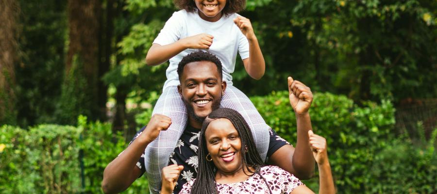 Two adult and one child playing