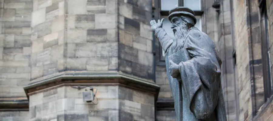 Colour photo of the John Knox statue in the New College Quad