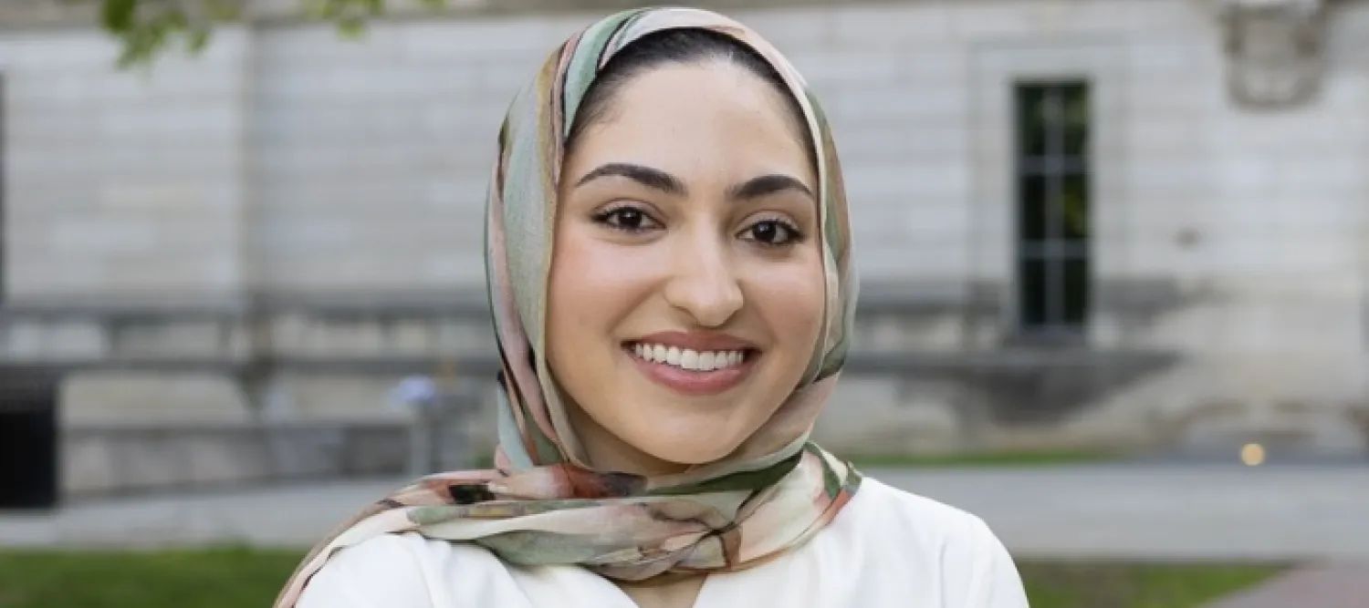 Colour head and shoulders photo of Haanya Ijaz smiling at the camera
