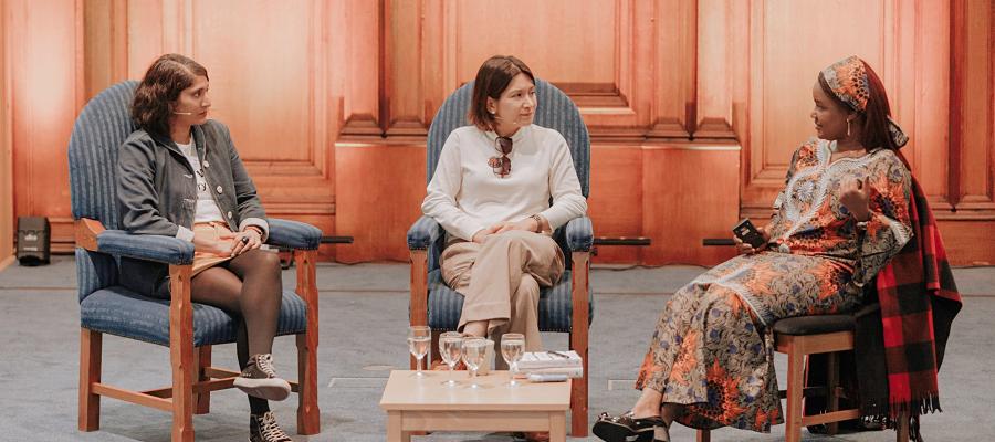 three authors chat on the stage
