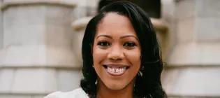 Colour head and shoulders photo of Dr Selina Stone smiling at the camera