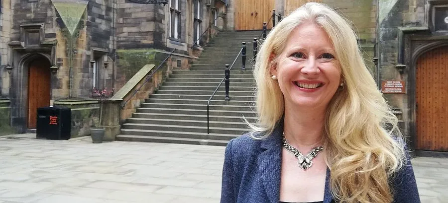 Professor Helen Bond in the quadrangle of New College