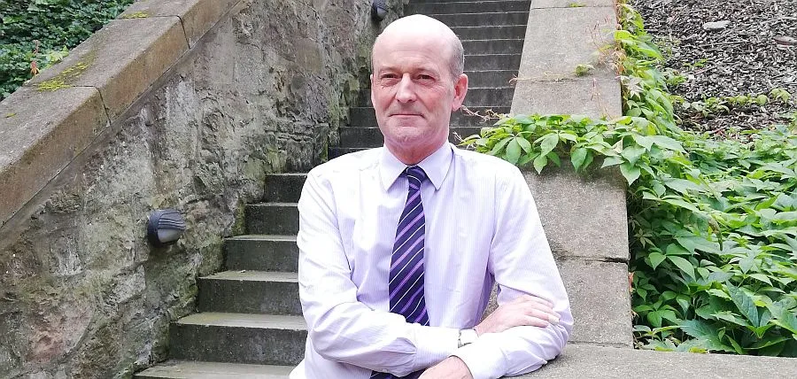 Professor Fergusson standing in New College garden