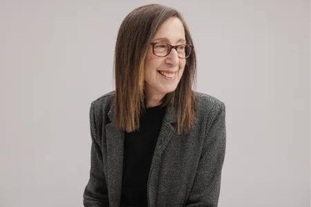 Colour head and shoulders photo of Manya Wilkinson smiling