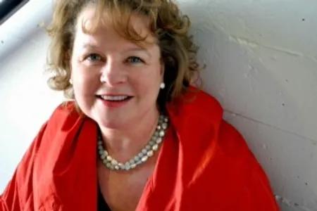 Colour photo of Linda McLean smiling at the camera