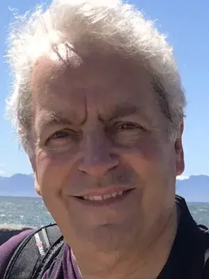 Colour head and shoulders photo of David Neville smiling at the camera