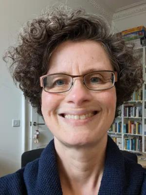 Colour head and shoulders photo of Professor Hannah Holtschneider smiling at the camera