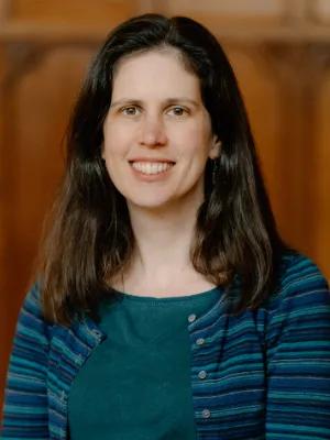 Colour head and shoulders photo of Professor Naomi Appleton smiling at the camera