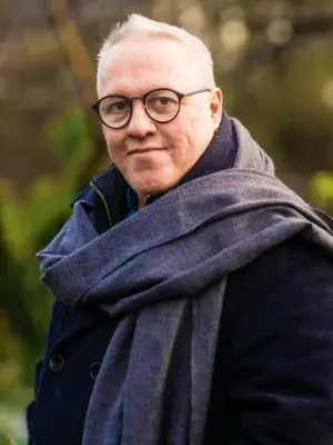 Colour head and shoulders photo of Lloyd Llewellyn-Jones smiling at the camera