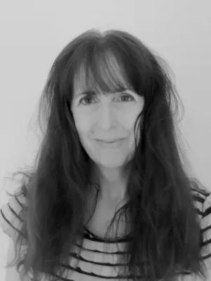 Black and White photo of Jane McKie smiling at the camera