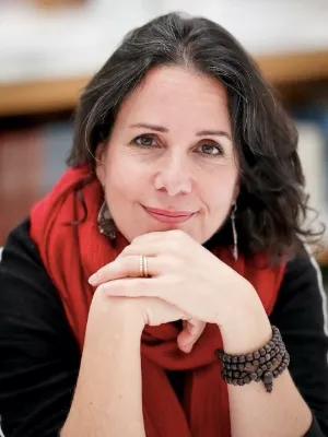 Colour head and shoulders photo of Vanessa R Sasson smiling at the camera