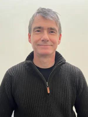 Colour head and shoulders photo of Professor Gordon Lynch smiling at the camera