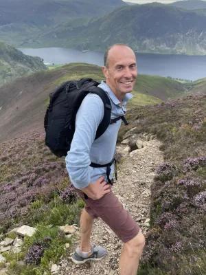 Colour photo of Professor Joylon Mitchell on a hill