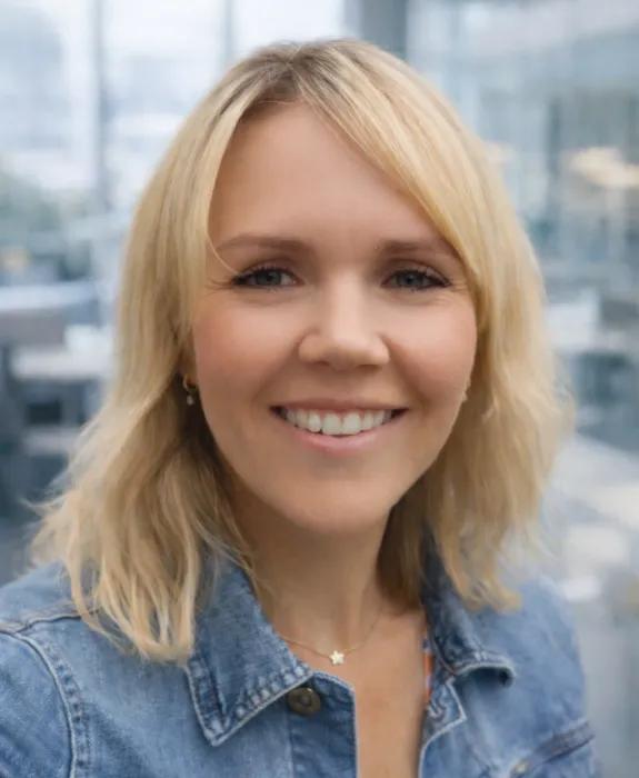 Colour head and shoulders photo of Amy Wilson smiling at the camera